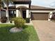 Charming single-story home with a well-manicured lawn and a brick driveway at 13172 Green Violet Dr, Riverview, FL 33579