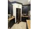Kitchen featuring stainless steel appliances, granite counters, tile backsplash, and dark cabinets at 13172 Green Violet Dr, Riverview, FL 33579
