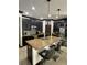Modern kitchen with granite island, dark cabinets, stainless appliances, and bar stool seating at 13172 Green Violet Dr, Riverview, FL 33579