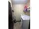 Functional laundry room with tile floor, washer, dryer, and shelf storage space at 13172 Green Violet Dr, Riverview, FL 33579