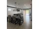 Open concept space with a dining table and view into the living room area at 13172 Green Violet Dr, Riverview, FL 33579
