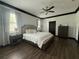 Bright main bedroom with hardwood floors, ceiling fan, and large windows providing lots of natural light at 13172 Green Violet Dr, Riverview, FL 33579