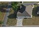 An aerial view capturing the home's layout, roofline, interlocking brick driveway, and its position on the corner lot at 13532 14Th St, Dade City, FL 33525