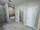 Bright bathroom featuring a separate shower and soaking tub, toilet, and door to commode at 13532 14Th St, Dade City, FL 33525