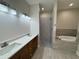 Modern bathroom with double vanity, shower, and tub at 13532 14Th St, Dade City, FL 33525
