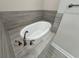 Stylish soaking tub with modern fixtures and tiled surround at 13532 14Th St, Dade City, FL 33525