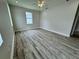 Bedroom featuring fresh paint, a window, and attractive laminate flooring at 13532 14Th St, Dade City, FL 33525