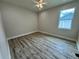 Spacious bedroom with modern ceiling fan, fresh paint, a window and attractive laminate flooring at 13532 14Th St, Dade City, FL 33525