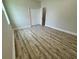 Large bedroom with a closet, freshly painted walls, a window, and attractive laminate flooring at 13532 14Th St, Dade City, FL 33525