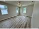Large bedroom with three windows, fresh paint, and attractive laminate flooring at 13532 14Th St, Dade City, FL 33525
