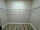 Walk-in closet with wood floor and wire shelves at 13532 14Th St, Dade City, FL 33525