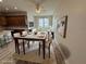 A bright, virtually staged dining room with modern furnishings, a marble top table, and natural light from the window at 13532 14Th St, Dade City, FL 33525