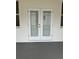 Elegant double doors provide access to the patio, complemented by a window for natural light at 13532 14Th St, Dade City, FL 33525