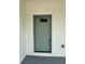 Stylish front door with a decorative glass insert and freshly painted trim at 13532 14Th St, Dade City, FL 33525