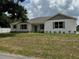 Beautiful one-story home with white painted brick and attractive front yard landscaping at 13532 14Th St, Dade City, FL 33525