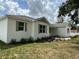 Beautiful one-story home with white painted brick, green trim and shutters and attractive front yard landscaping at 13532 14Th St, Dade City, FL 33525