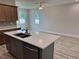 Modern kitchen featuring an island, stainless steel dishwasher and hardwood floors at 13532 14Th St, Dade City, FL 33525