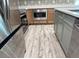 Kitchen featuring stainless steel appliances, microwave, grey floors, and wood cabinets at 13532 14Th St, Dade City, FL 33525
