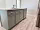 Kitchen island with a sink, stainless steel dishwasher, and ample storage at 13532 14Th St, Dade City, FL 33525