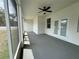 Large screened-in lanai with ceiling fan and access to the backyard at 13532 14Th St, Dade City, FL 33525