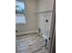 Bright laundry room with window, sink, and shelving at 13532 14Th St, Dade City, FL 33525