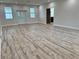 Bright living room featuring laminate wood flooring, recessed lighting, and freshly painted walls at 13532 14Th St, Dade City, FL 33525