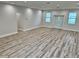 Bright living room featuring laminate wood flooring, recessed lighting, and freshly painted walls at 13532 14Th St, Dade City, FL 33525