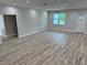 Bright living room featuring laminate wood flooring, recessed lighting, and freshly painted walls at 13532 14Th St, Dade City, FL 33525
