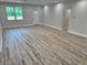 Bright living room featuring laminate wood flooring, recessed lighting, and freshly painted walls at 13532 14Th St, Dade City, FL 33525