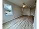 Brightly lit living room area with wood floors and neutral paint at 13532 14Th St, Dade City, FL 33525
