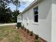 Exterior of single-story home featuring white stucco and well-maintained landscaping at 13532 14Th St, Dade City, FL 33525
