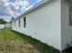 Exterior of single-story home featuring white stucco and well-maintained landscaping at 13532 14Th St, Dade City, FL 33525