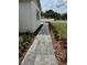 Landscaped walkway leading to the home, with brick pavers and fresh mulch at 13532 14Th St, Dade City, FL 33525