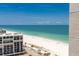 An aerial view of a beach featuring the ocean, sand, and buildings at 1390 Gulf Blvd # Ph-5, Clearwater, FL 33767