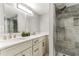 Bathroom featuring double sinks, vanity, mirror, and shower at 1390 Gulf Blvd # Ph-5, Clearwater, FL 33767