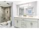 Modern bathroom with double vanity, stylish mirror, and tile walk-in shower at 1390 Gulf Blvd # Ph-5, Clearwater, FL 33767