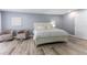 Bedroom with two swivel chairs, wood floors, and a door to the hallway at 1390 Gulf Blvd # Ph-5, Clearwater, FL 33767