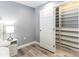 The bedroom features a closet with custom built-ins and wood laminate flooring at 1390 Gulf Blvd # Ph-5, Clearwater, FL 33767