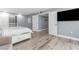 Bedroom with closet, attached bathroom, and large television at 1390 Gulf Blvd # Ph-5, Clearwater, FL 33767