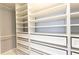 This walk-in closet has custom white built-in shelving and drawers for maximum storage and organization at 1390 Gulf Blvd # Ph-5, Clearwater, FL 33767