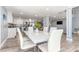 Open concept dining area with stainless steel hardware on table and view to kitchen at 1390 Gulf Blvd # Ph-5, Clearwater, FL 33767