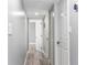 Hallway featuring wood-look floors and white doors at 1390 Gulf Blvd # Ph-5, Clearwater, FL 33767