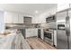 Bright kitchen featuring stainless steel appliances, white cabinets, granite countertops and new hardware at 1390 Gulf Blvd # Ph-5, Clearwater, FL 33767