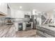 Modern kitchen with stainless steel appliances, white cabinets, granite countertops and wine fridge at 1390 Gulf Blvd # Ph-5, Clearwater, FL 33767