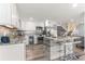 Modern kitchen with stainless steel appliances, white cabinets, granite countertops and breakfast bar at 1390 Gulf Blvd # Ph-5, Clearwater, FL 33767