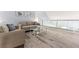 Upstairs sitting area featuring a modern glass coffee table and comfortable seating at 1390 Gulf Blvd # Ph-5, Clearwater, FL 33767