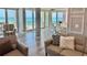 Bright living room with luxurious seating and breathtaking ocean views from sliding glass doors at 1390 Gulf Blvd # Ph-5, Clearwater, FL 33767