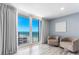 This well-lit living room features sliding glass doors, tile floors, and comfortable seating at 1390 Gulf Blvd # Ph-5, Clearwater, FL 33767