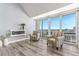 Sitting area with striped chairs, modern decor, and stunning waterfront views at 1390 Gulf Blvd # Ph-5, Clearwater, FL 33767