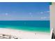 Balcony ocean view of a white sandy beach with turquoise water and sailboat at 1390 Gulf Blvd # Ph-5, Clearwater, FL 33767